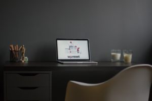 macbook air on black wooden desk